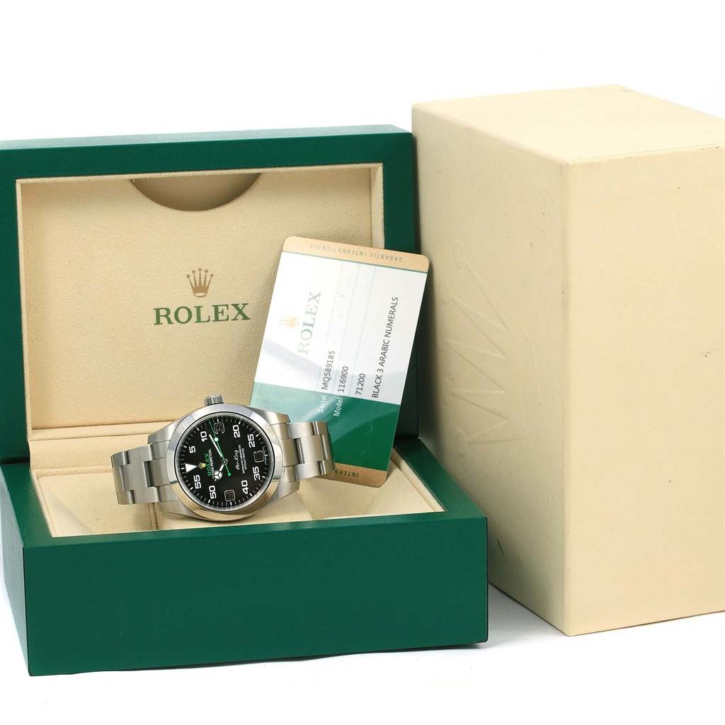 The Rolex Air-King 116900 Men's Stainless Steel Black Dial 116900 Men's Stainless Steel Black Dial watch is shown from a front view in its green display box, accompanied by documentation.