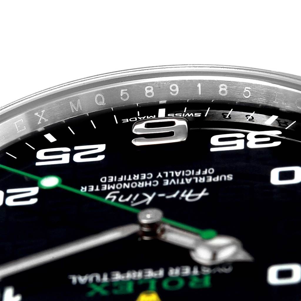 This close-up angle of the Rolex Air-King 116900 Men's Stainless Steel Black Dial 116900 Men's Stainless Steel Black Dial watch shows parts of the dial, hands, and the inner bezel with serial markings.
