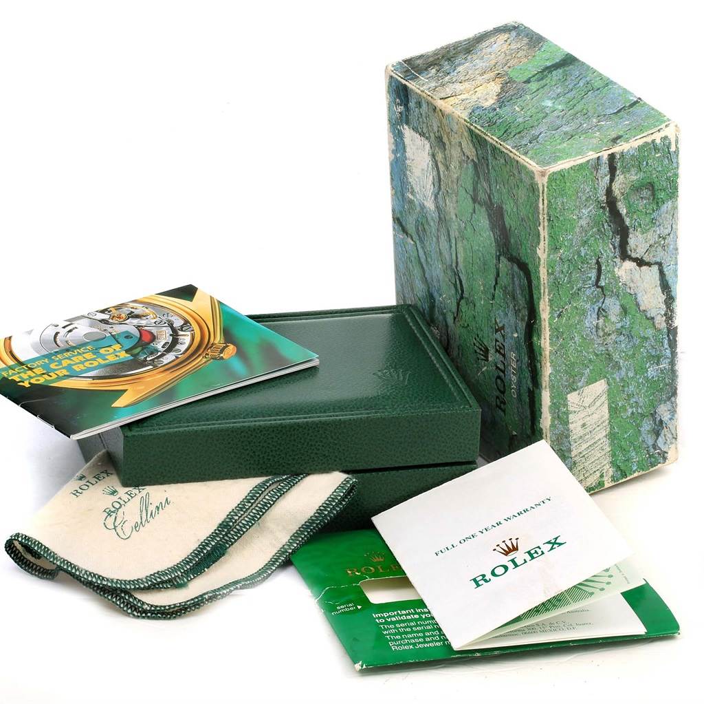 The image shows the packaging and accessories of a Rolex Air-King 14000 Men's Stainless Steel Blue Dial 14000 Men's Stainless Steel Blue Dial, including the box, manual, warranty card, and cleaning cloth.