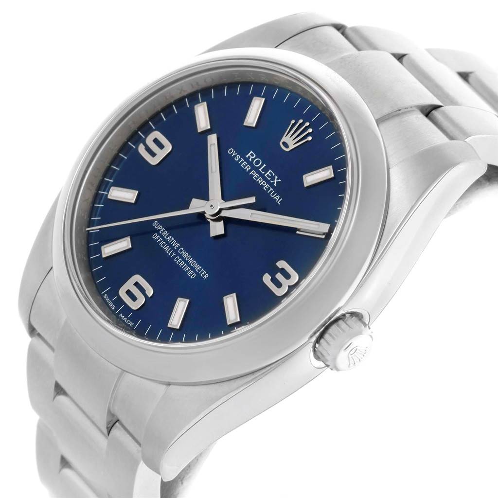 The Rolex Air-King 114200 Men's Stainless Steel Blue Dial 114200 Men's Stainless Steel Blue Dial watch is shown at an angled side view displaying its blue face, dial, crown, and stainless steel bracelet.
