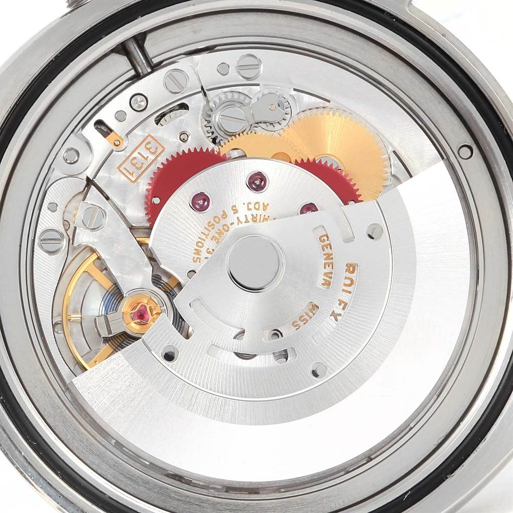 The image shows a close-up view of the internal mechanism of the Rolex Air-King 116900 Men's Stainless Steel Black Dial 116900 Men's Stainless Steel Black Dial watch, highlighting its gears and components.