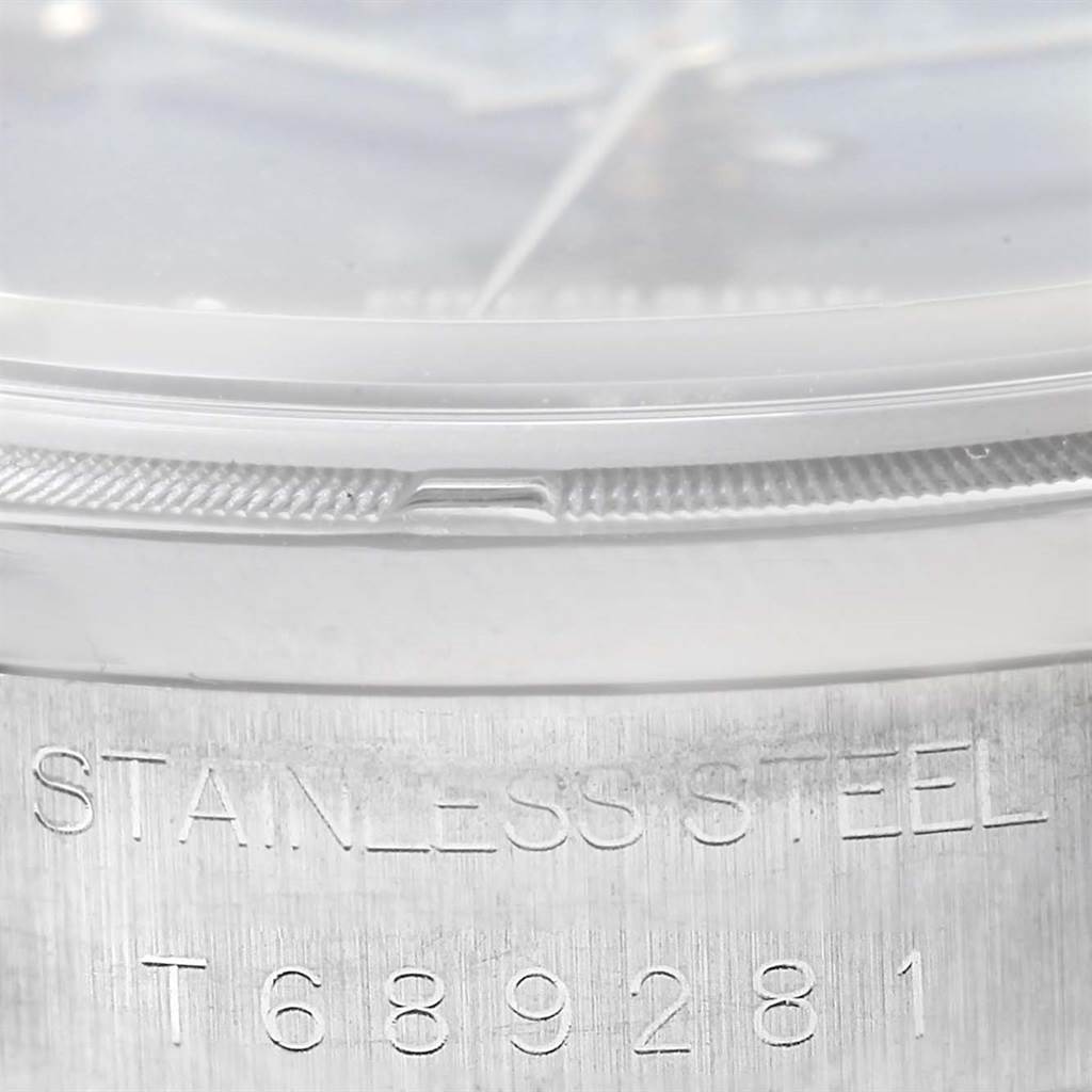 This close-up image of the Rolex Air-King 14010 Men's Stainless Steel Blue Dial 14010 Men's Stainless Steel Blue Dial watch shows the edge of the case and the serial number engraved on the stainless steel.