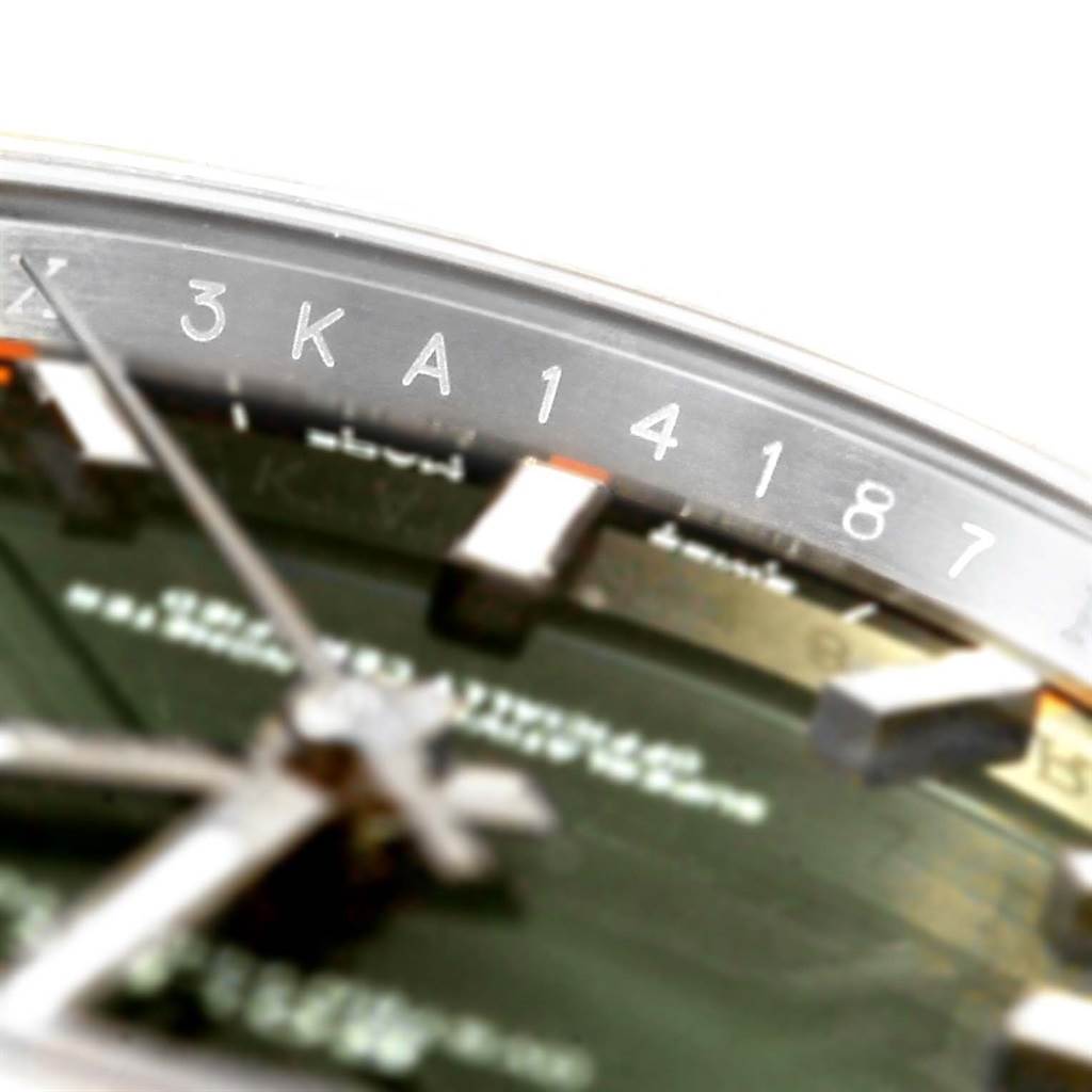 This close-up angle of the Rolex Air-King 114200 Men's Stainless Steel Green Dial 114200 Men's Stainless Steel Green Dial watch shows the edge of the dial, part of the hands, and a portion of the serial number.