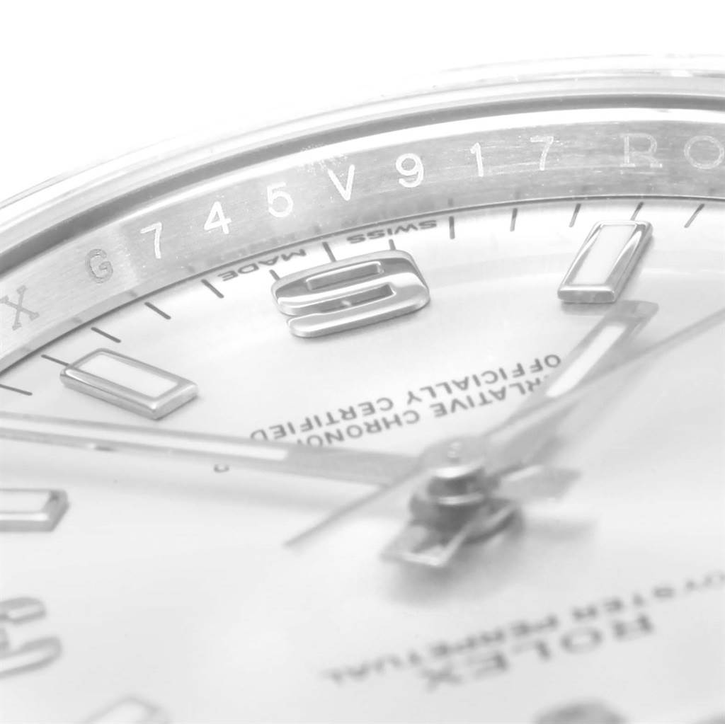 This close-up angle of the Rolex Air-King 114200 Stainless Steel Silver Dial 114200 Stainless Steel Silver Dial watch shows parts of the dial, hands, and inner bezel with serial numbers.