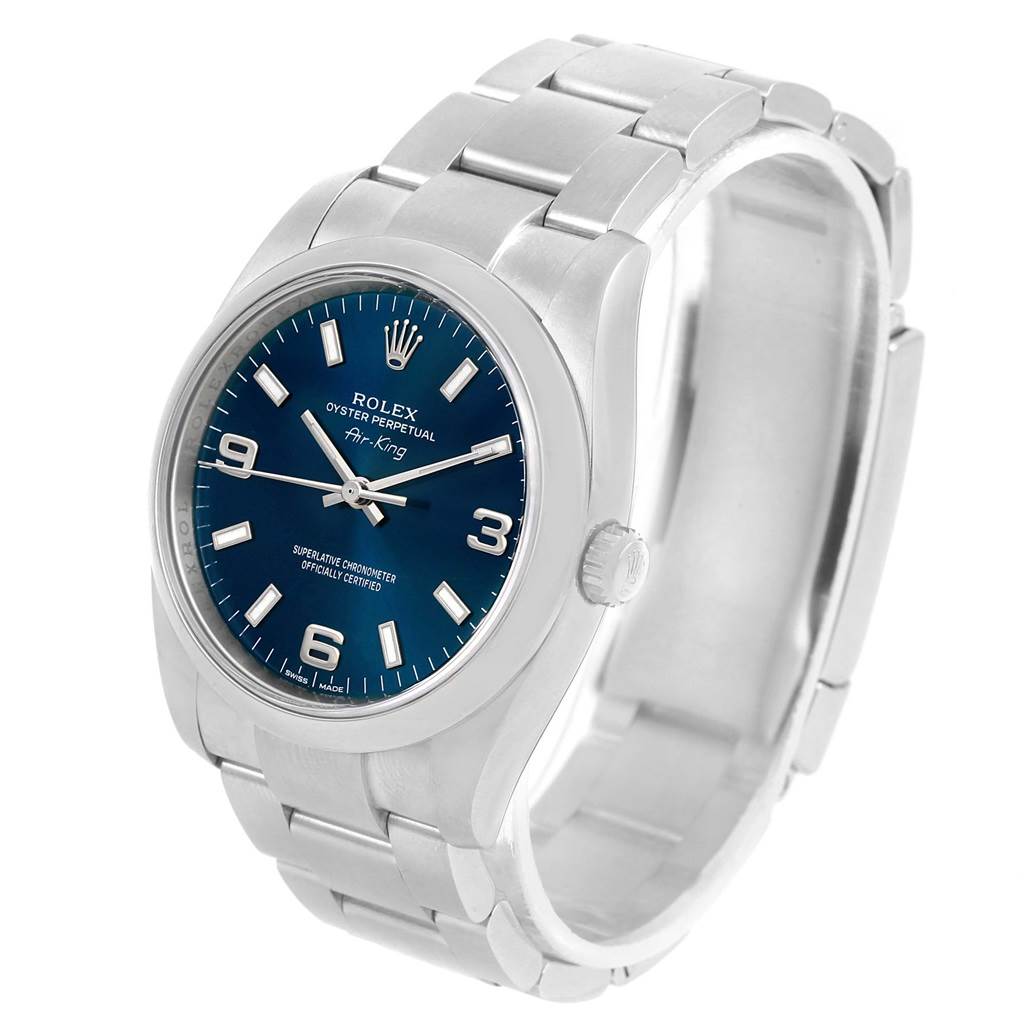 The Rolex Air-King 114200 Men's Stainless Steel Blue Dial 114200 Men's Stainless Steel Blue Dial watch is shown at a three-quarter angle, highlighting the face, bezel, case, and metal bracelet.