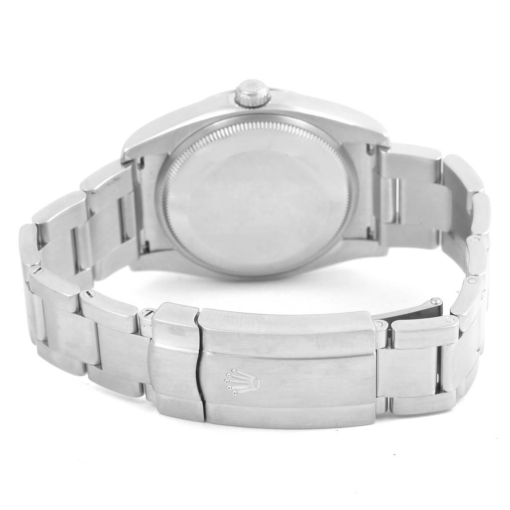 The image shows the back view of a Rolex Air-King 114200 Men's Stainless Steel Blue Dial 114200 Men's Stainless Steel Blue Dial watch, highlighting the case back, crown, and clasp of the metal bracelet.