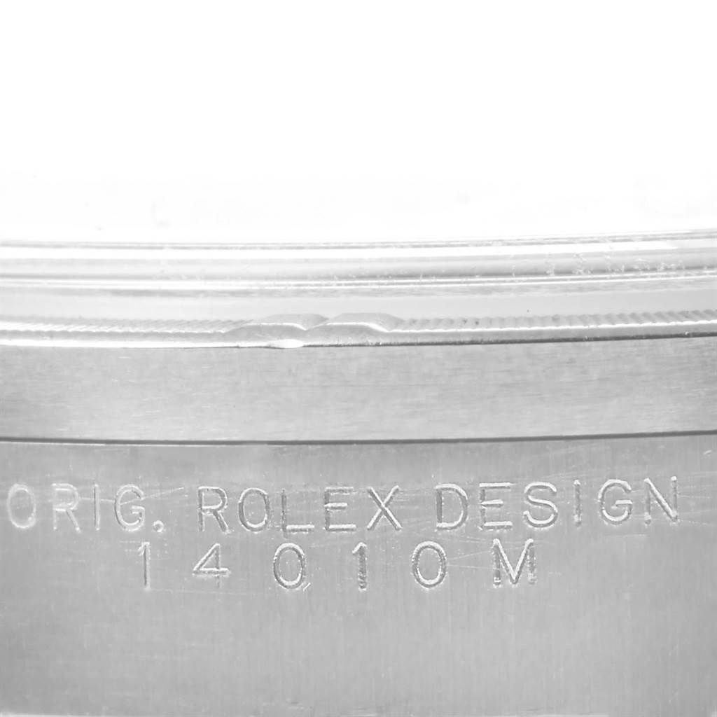 The image shows a close-up of the Rolex Air-King 14010 Men's Stainless Steel Blue Dial 14010 Men's Stainless Steel Blue Dial case with the inscription "ORIG. ROLEX DESIGN 14010M."