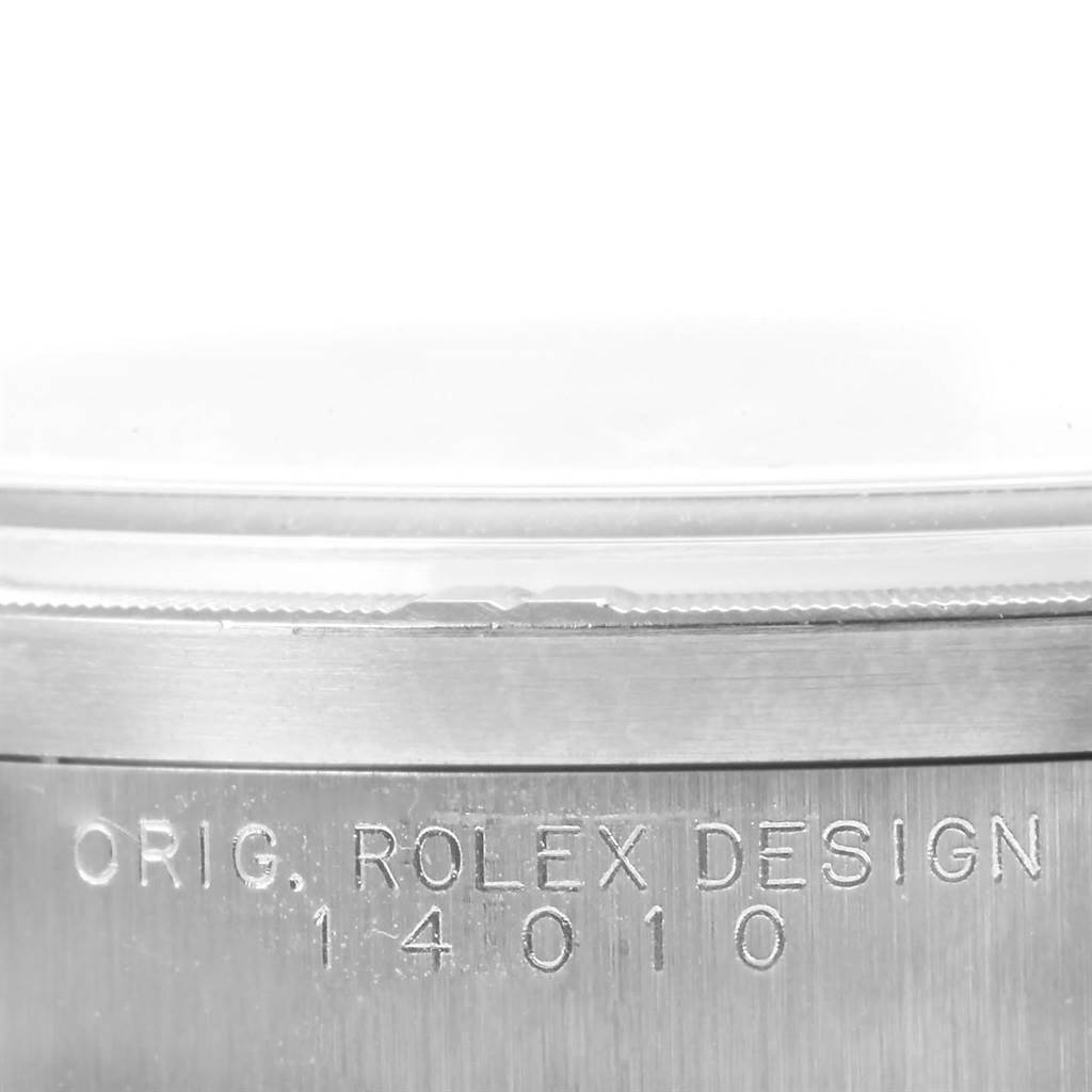 The image shows a close-up of the side of a Rolex Air-King 14010 Men's Stainless Steel Silver Dial 14010 Men's Stainless Steel Silver Dial watch, highlighting the engraved model number "14010" and "ORIG. ROLEX DESIGN".