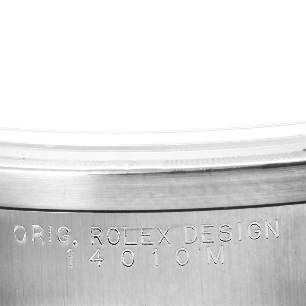This image shows a close-up of the case side of a Rolex Air-King 14010 Men's Stainless Steel Silver Dial 14010 Men's Stainless Steel Silver Dial watch, displaying its model number and "ORIG. ROLEX DESIGN" engraving.