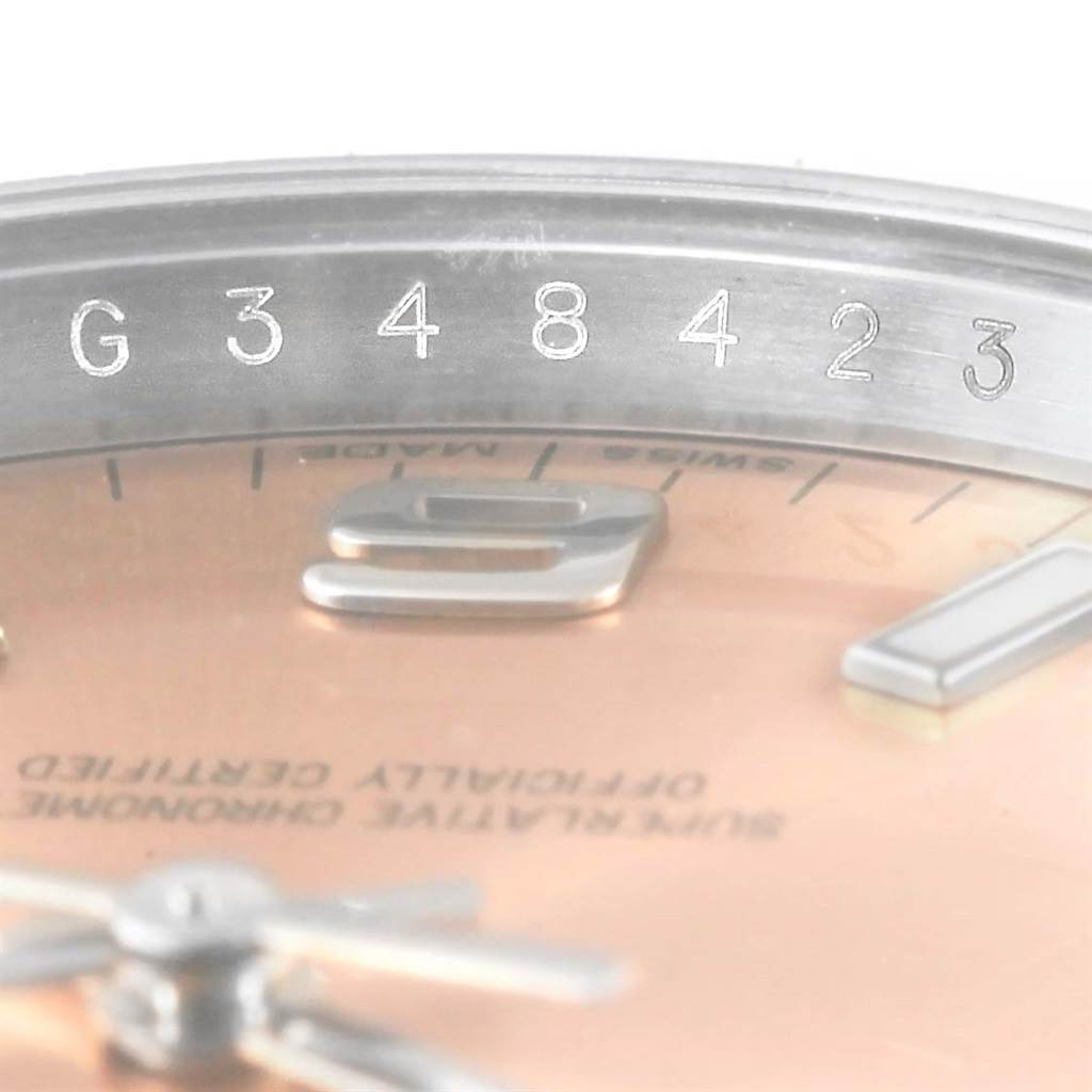 The image shows a close-up of the serial number and partial face of a Rolex Air-King 114200 Men's Stainless Steel Pink Dial 114200 Men's Stainless Steel Pink Dial watch, revealing parts of the dial and case.
