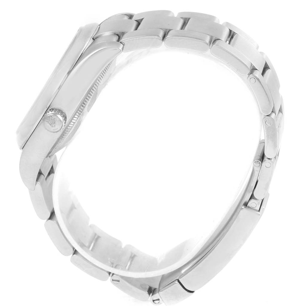 The image shows a side view of a Rolex Air-King 114200 Men's Stainless Steel Pink Dial 114200 Men's Stainless Steel Pink Dial watch, emphasizing its band and crown.