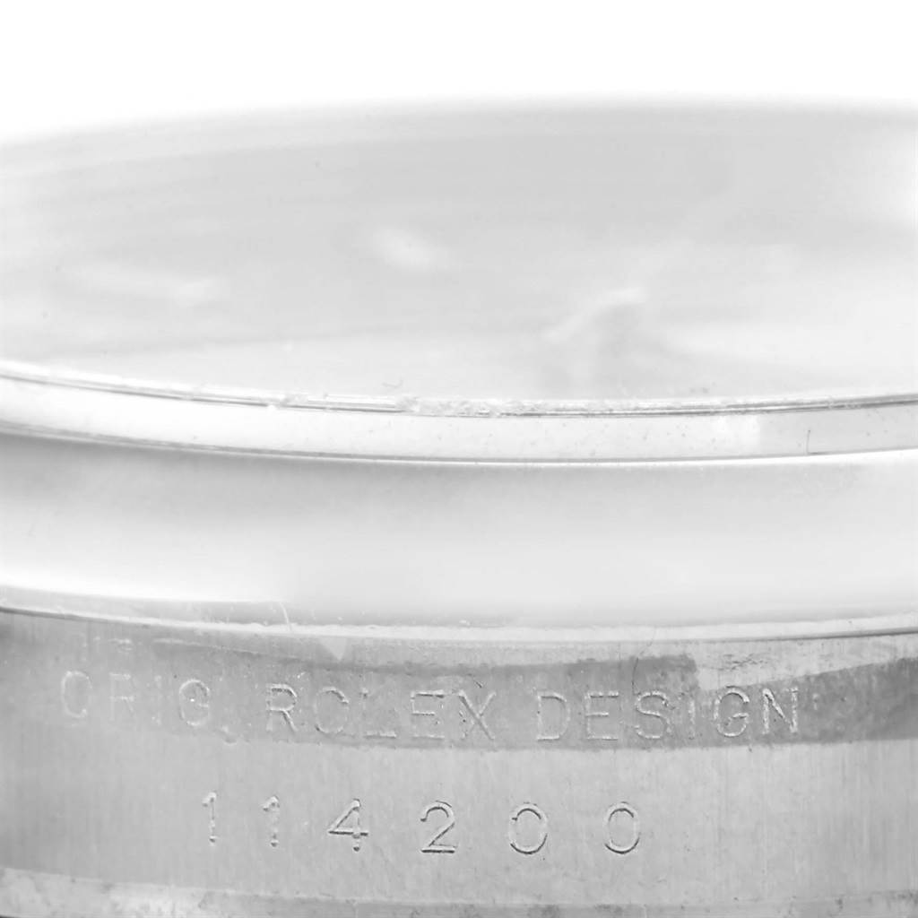 This close-up image shows the case side of a Rolex Air-King 114200 Men's Stainless Steel Pink Dial 114200 Men's Stainless Steel Pink Dial watch, highlighting its engraved model number 114200.