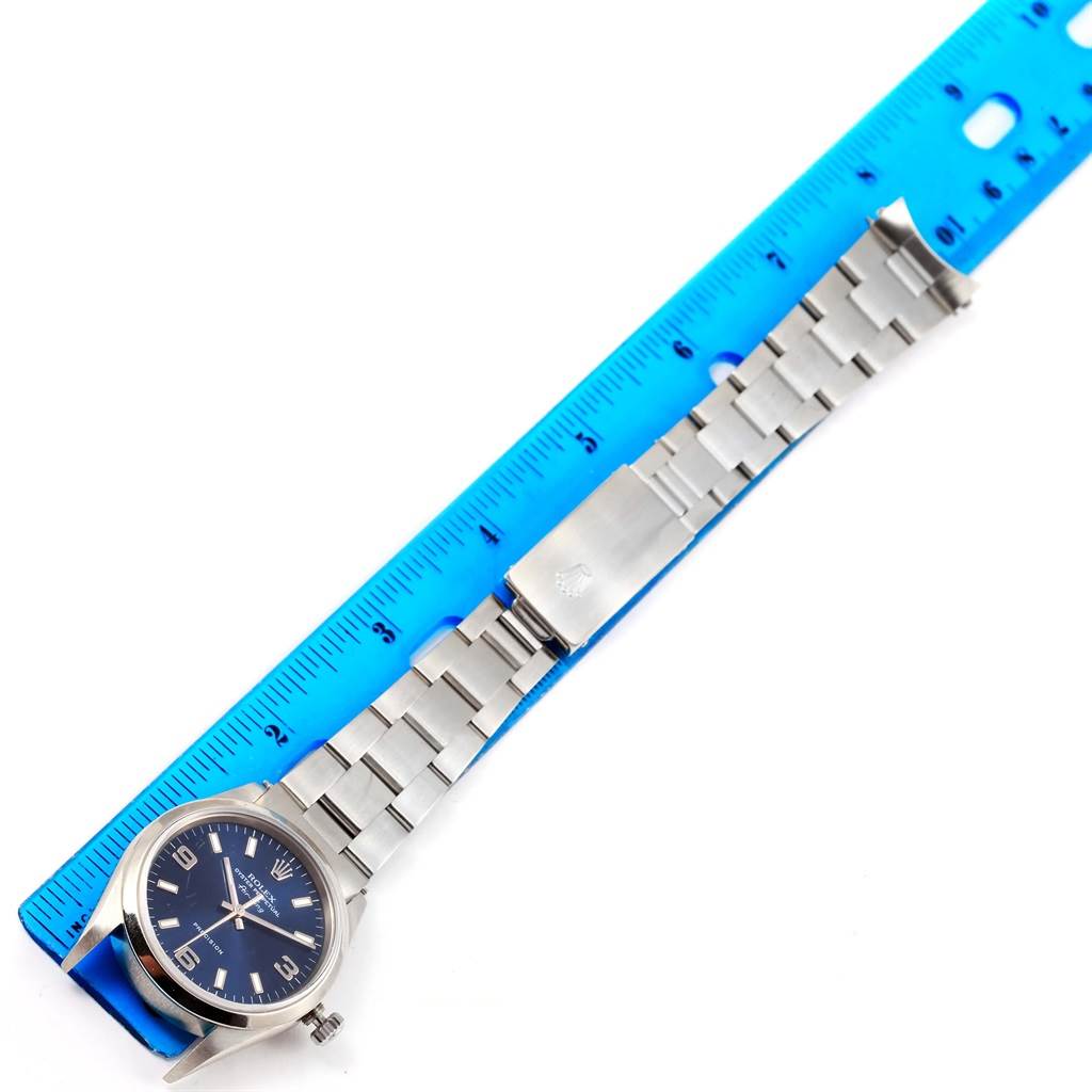 The image shows a Rolex Air-King 14000 Men's Stainless Steel Blue Dial 14000 Men's Stainless Steel Blue Dial watch laid flat with the face, bracelet, and clasp visible, next to a blue ruler.