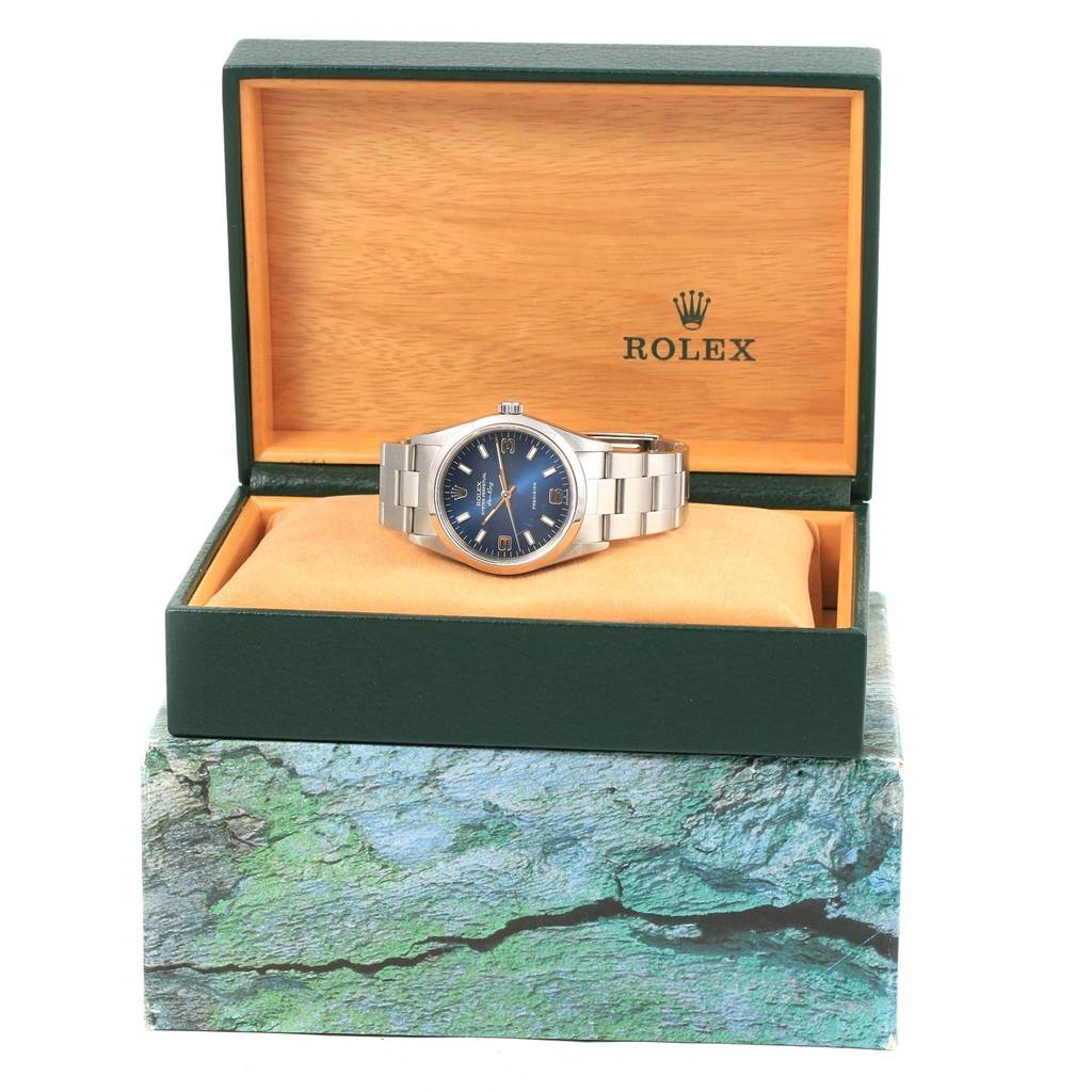 The Rolex Air-King 14000 Men's Stainless Steel Blue Dial 14000 Men's Stainless Steel Blue Dial watch is shown at a frontal angle inside its branded open green box with a cushion.