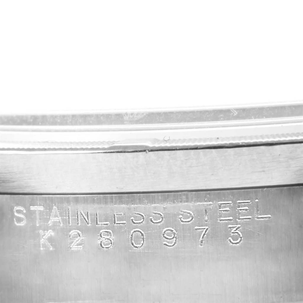 The image shows the side of the stainless steel case of a Rolex Air-King 14010 Men's Stainless Steel Silver Dial 14010 Men's Stainless Steel Silver Dial watch with the serial number engraved.