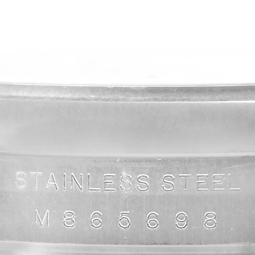 This image shows a close-up of the side of a Rolex Air-King 114200 Men's Stainless Steel Silver Dial 114200 Men's Stainless Steel Silver Dial watch, highlighting the stainless steel material and serial number.