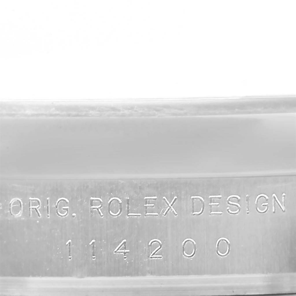 This close-up image shows the engraving of the model number on the inner case of a Rolex Air-King 114200 Men's Stainless Steel Silver Dial 114200 Men's Stainless Steel Silver Dial watch.