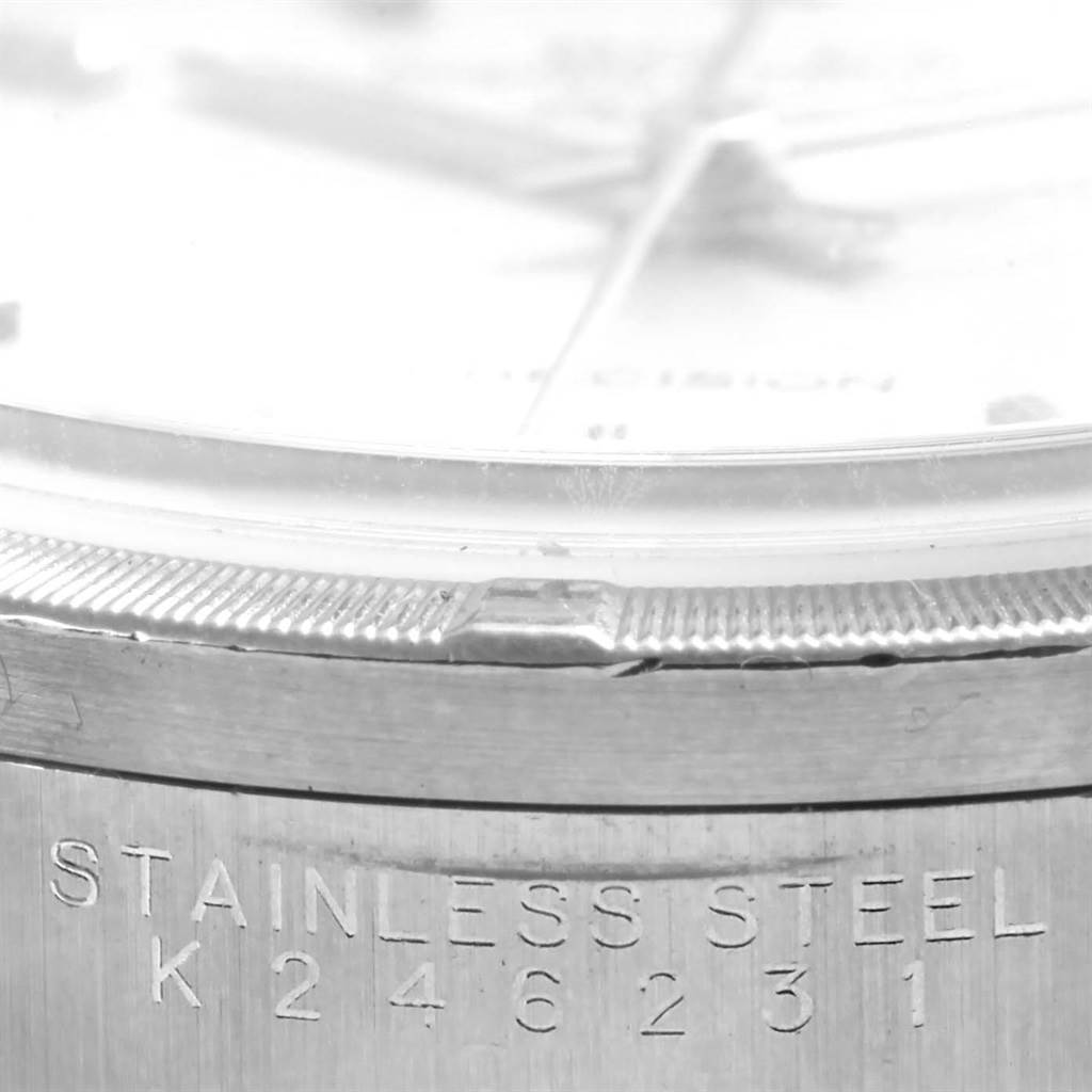 This close-up image of a Rolex Air-King 14010 Men's Stainless Steel Silver Dial 14010 Men's Stainless Steel Silver Dial watch shows the stainless steel case with the engraved serial number.