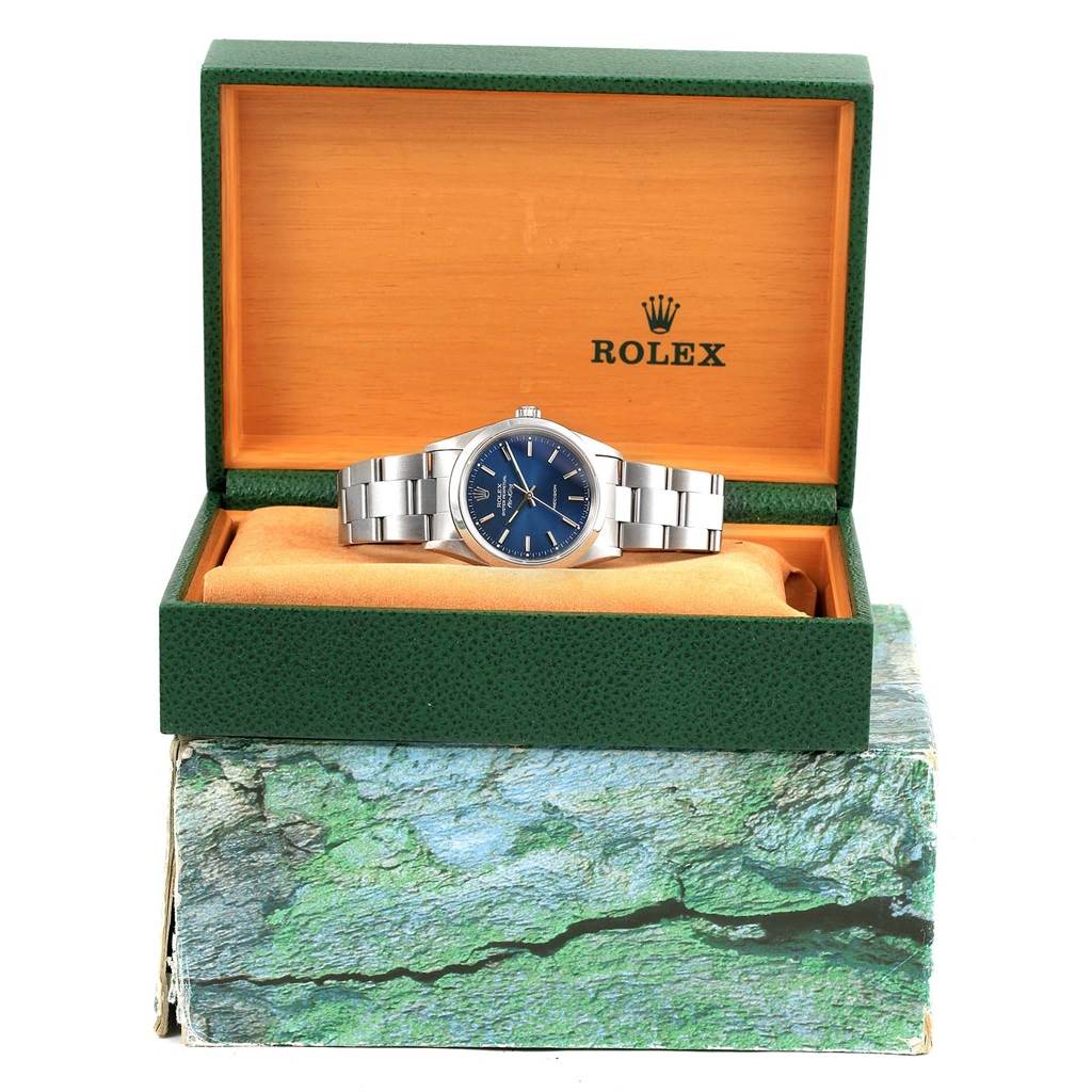 The Rolex Air-King 14000 Men's Stainless Steel Blue Dial 14000 Men's Stainless Steel Blue Dial watch is shown from a front angle inside an open green and orange Rolex box, with the bracelet fully visible.
