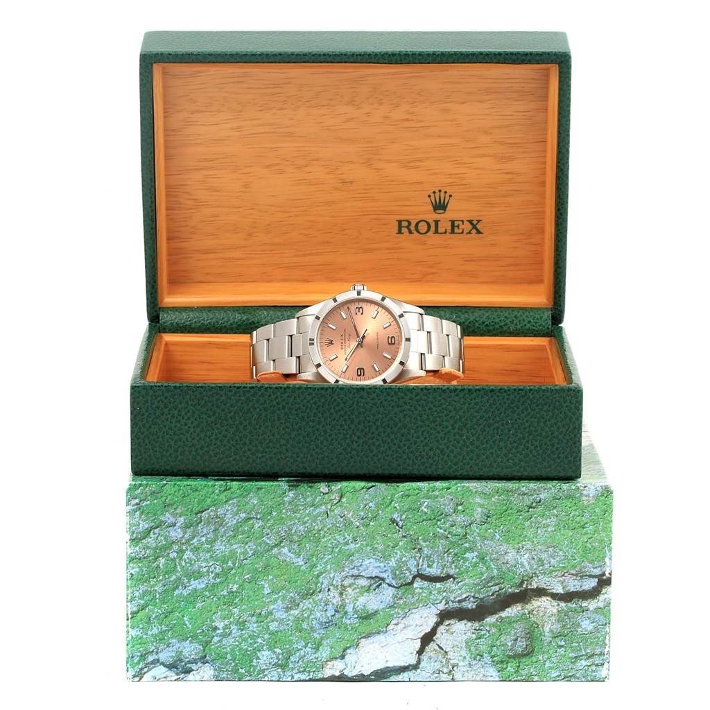 The Rolex Air-King 14010 Stainless Steel Pink Dial 14010 Stainless Steel Pink Dial watch is displayed front-on in an open green and wooden box.