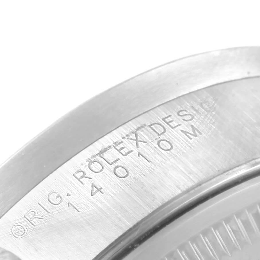 The image shows a close-up of the engraved bezel of a Rolex Air-King 14010 Stainless Steel Pink Dial 14010 Stainless Steel Pink Dial watch, focusing on the model number "14010M".