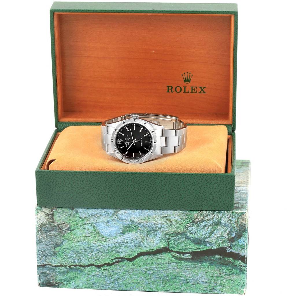The Rolex Air-King 14010 Men's Stainless Steel Black Dial 14010 Men's Stainless Steel Black Dial watch is displayed frontally inside an open green and wooden box.