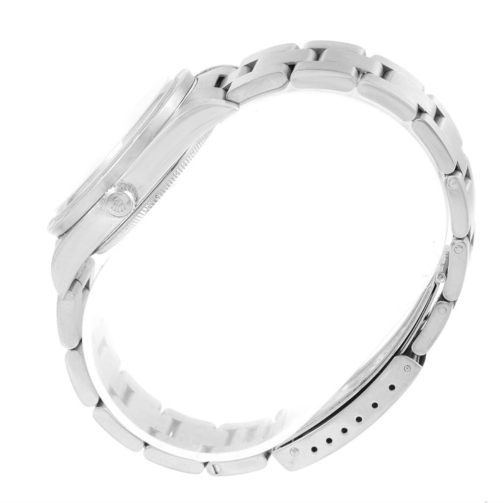 This side view of the Rolex Air-King 14010 Men's Stainless Steel Black Dial 14010 Men's Stainless Steel Black Dial watch shows its crown, case, and linked bracelet.