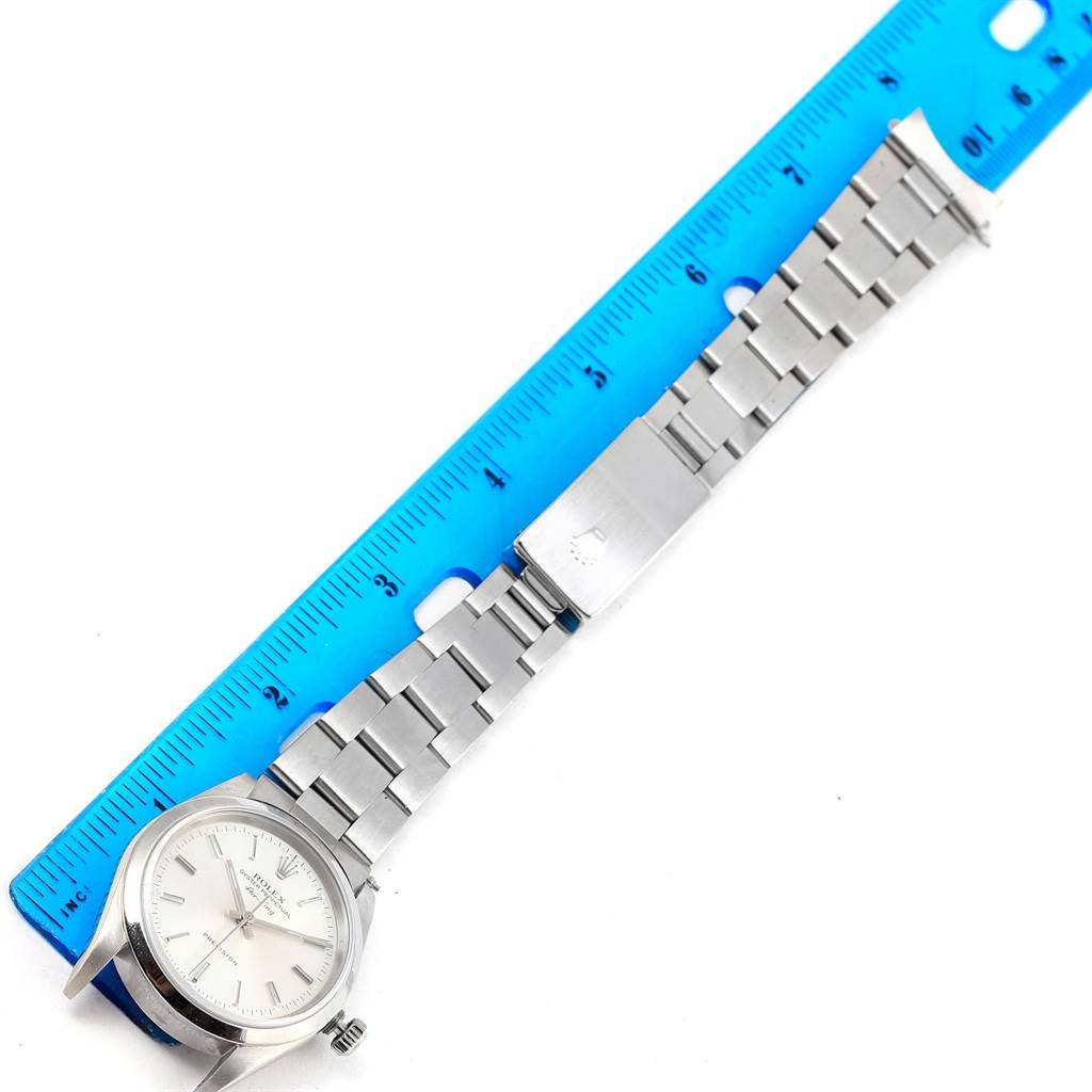 The image shows a Rolex Air-King 14000 Men's Stainless Steel Silver Dial 14000 Men's Stainless Steel Silver Dial wristwatch laid flat with a ruler beside it, highlighting the watch case, bracelet, and clasp.