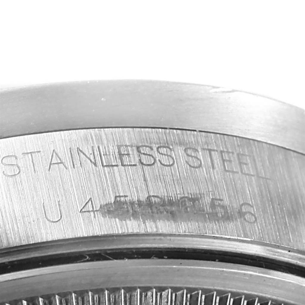 The image shows a close-up of the case back edge with "Stainless Steel" engraving on a Rolex Air-King 14010 Men's Stainless Steel Blue Dial 14010 Men's Stainless Steel Blue Dial model watch.