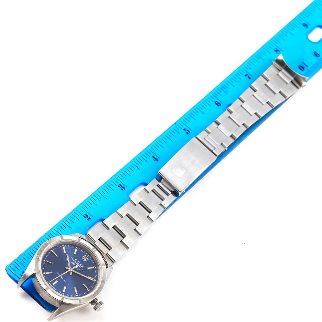 The image shows a Rolex Air-King 14010 Men's Stainless Steel Blue Dial 14010 Men's Stainless Steel Blue Dial watch laid flat with a blue ruler for size reference.