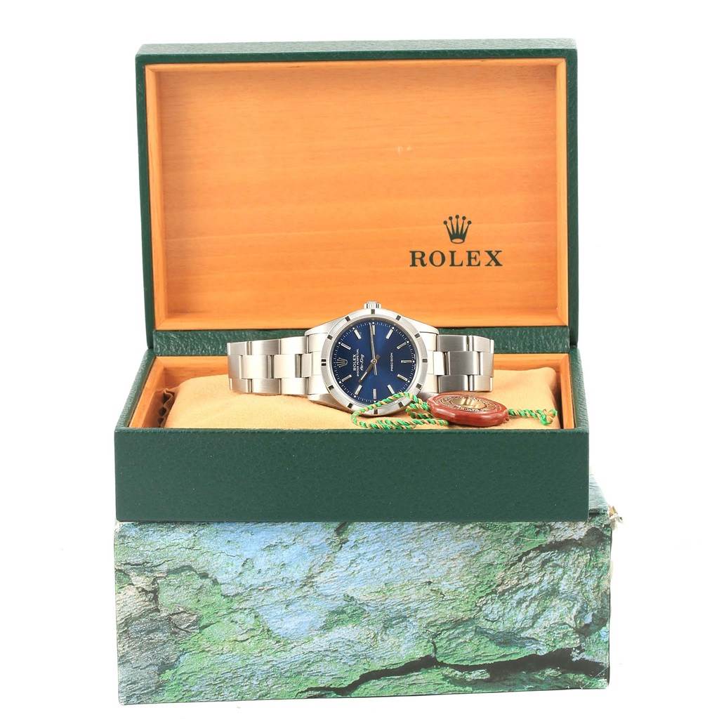 This image shows a Rolex Air-King 14010 Men's Stainless Steel Blue Dial 14010 Men's Stainless Steel Blue Dial watch inside its open green box, showcasing the watch face, bracelet, and tags.
