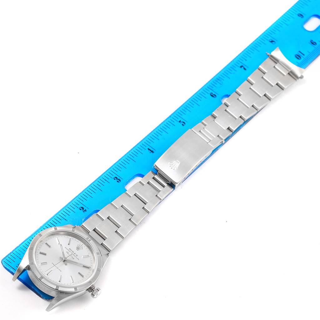 The Rolex Air-King 14010 Men's Stainless Steel Silver Dial 14010 Men's Stainless Steel Silver Dial watch is shown from a top-down angle, displaying the face, bracelet, and clasp alongside a ruler for size reference.