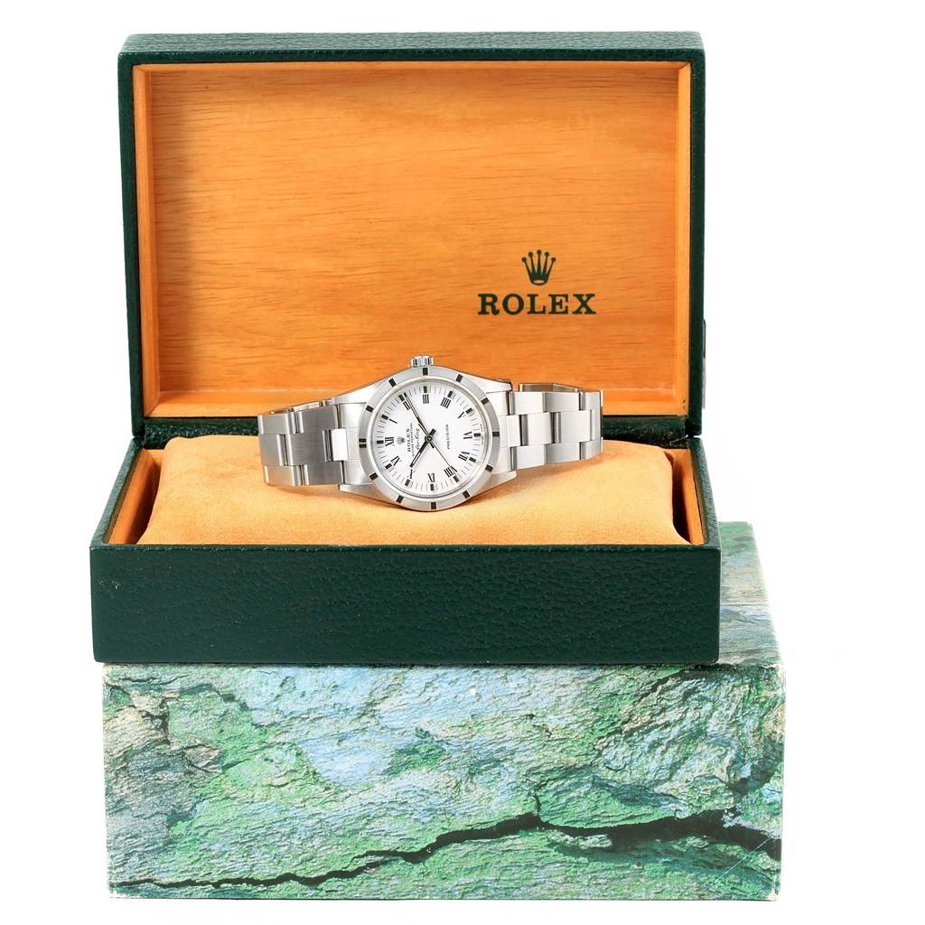 The Rolex Air-King 14010 Men's Stainless Steel White Dial 14010 Men's Stainless Steel White Dial watch is displayed inside an open green and wood-colored box, showing a frontal view of the watch face and bracelet.