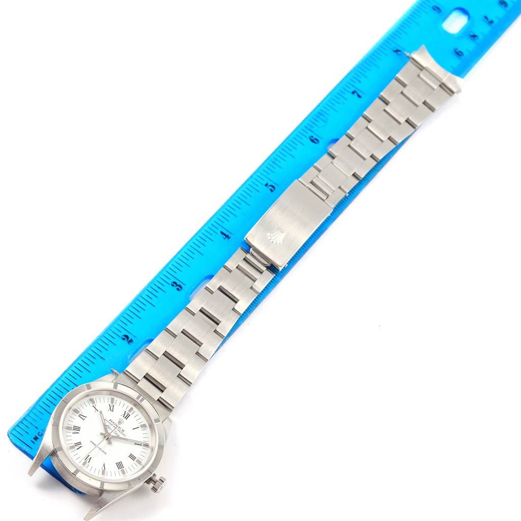 The image shows a Rolex Air-King 14010 Men's Stainless Steel White Dial 14010 Men's Stainless Steel White Dial watch laid flat, with the face and band next to a blue ruler for scale.