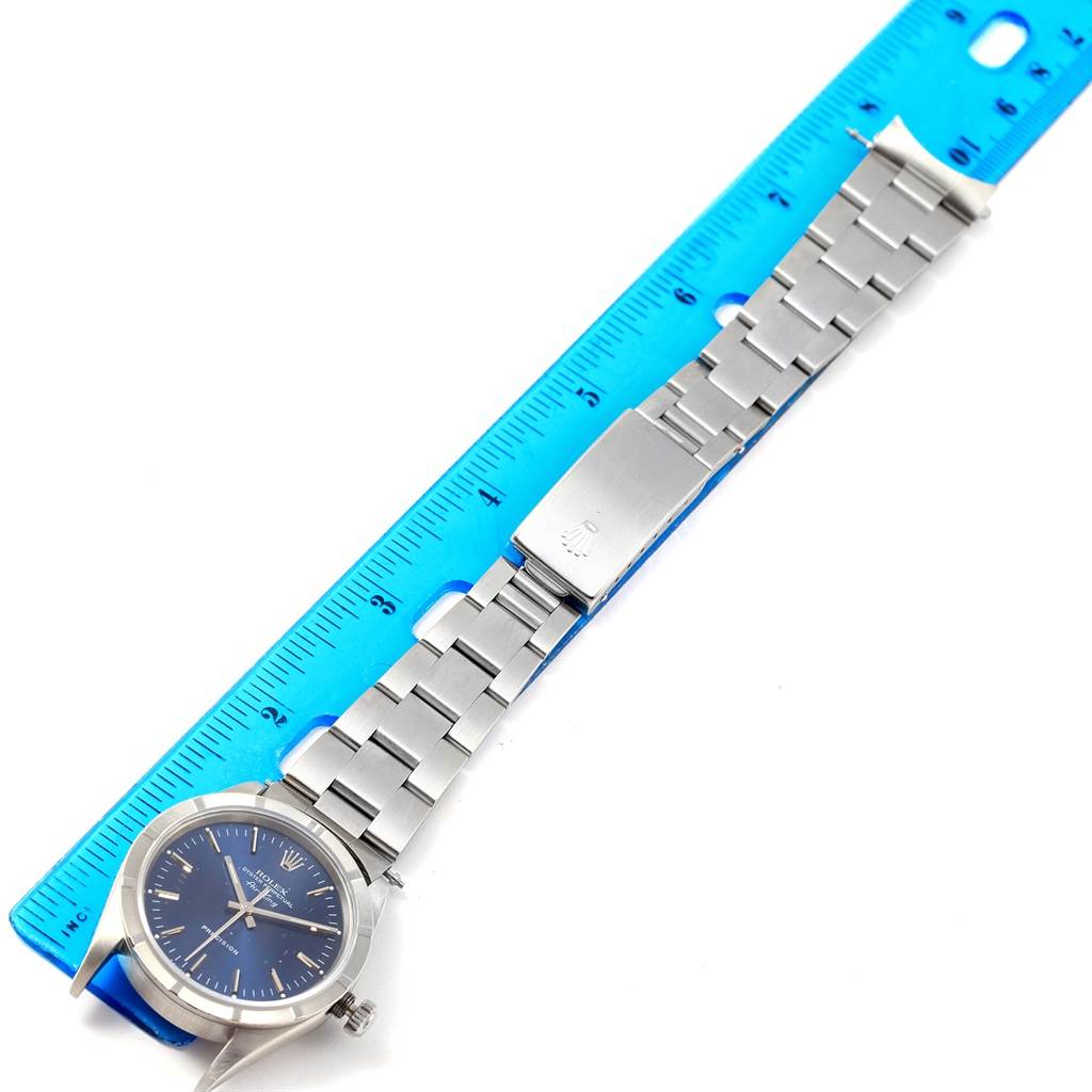 The image shows a Rolex Air-King 14010 Men's Stainless Steel Blue Dial 14010 Men's Stainless Steel Blue Dial watch placed flat, displaying the bracelet, clasp, and part of the dial, with a ruler next to it.