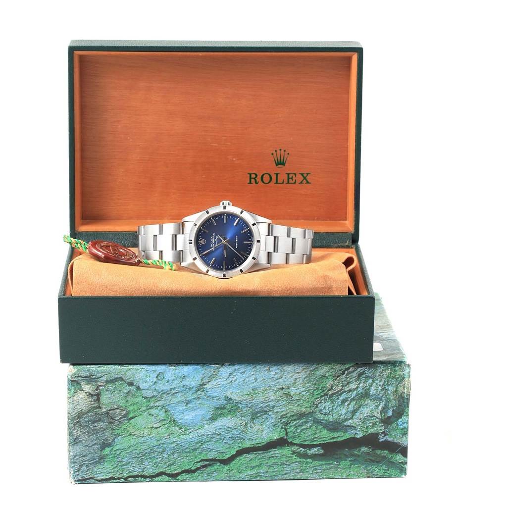 The Rolex Air-King 14010 Men's Stainless Steel Blue Dial 14010 Men's Stainless Steel Blue Dial watch is displayed front-on in its open box, showcasing its blue dial and silver bracelet.
