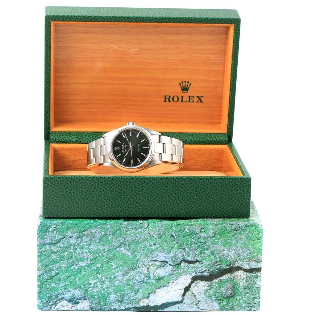 The Rolex Air-King 14000 Men's Stainless Steel Black Dial 14000 Men's Stainless Steel Black Dial watch is displayed front-on in an open green and wooden presentation box.