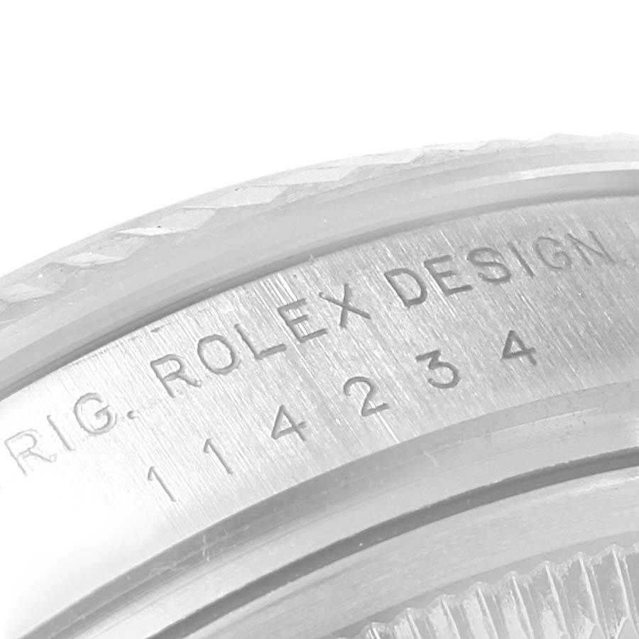 This close-up image shows the case back of the Rolex Air-King 114234 Men's Stainless Steel Blue Dial 114234 Men's Stainless Steel Blue Dial watch, featuring the serial number and "Rolex Design" engraving.