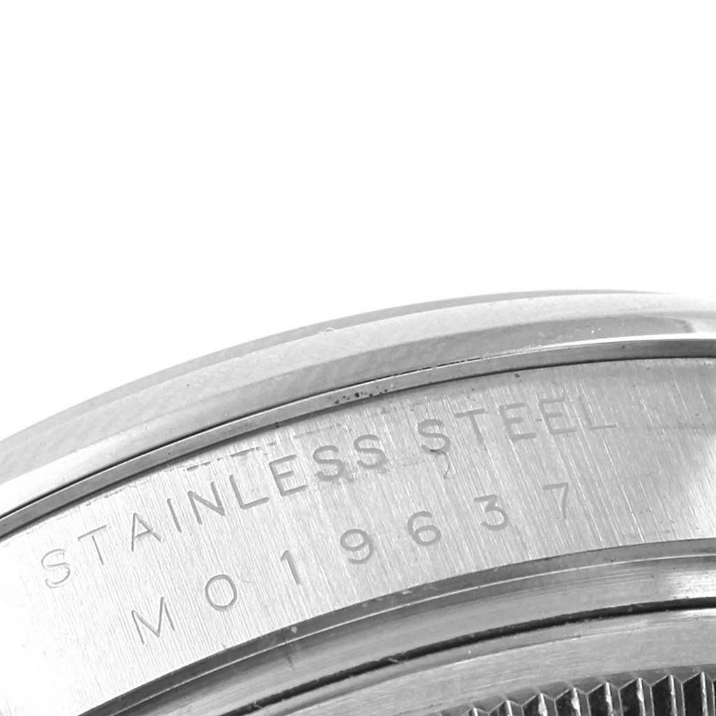 This image shows a close-up of the case back of a Rolex Air-King 114200 Stainless Steel Silver Dial 114200 Stainless Steel Silver Dial watch with engraved text.