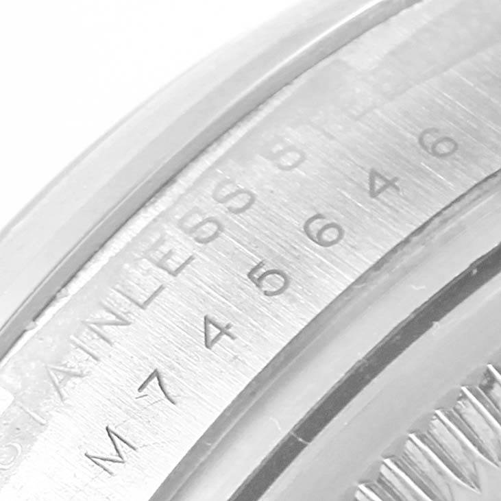 The image shows a close-up of the casing and serial number of a Rolex Air-King 114200 Stainless Steel Blue Dial 114200 Stainless Steel Blue Dial watch.