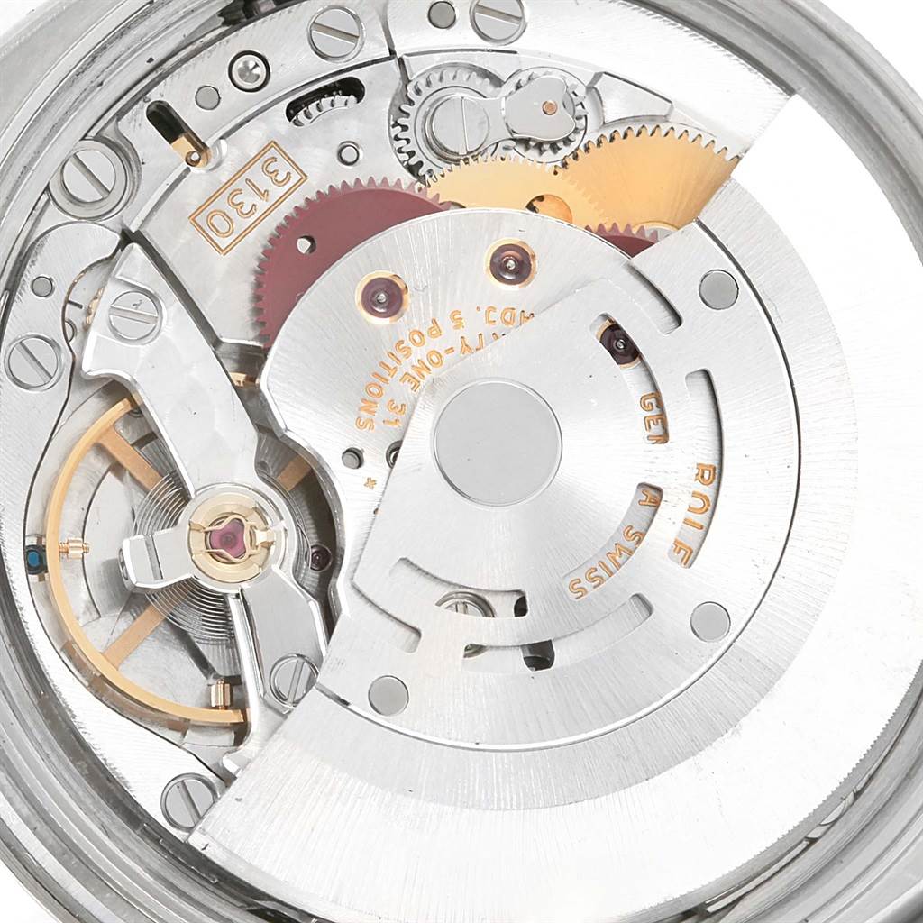 The image shows the internal mechanism of a Rolex Air-King 114200 Men's Stainless Steel Silver Dial 114200 Men's Stainless Steel Silver Dial watch, focusing on the movement and gears.