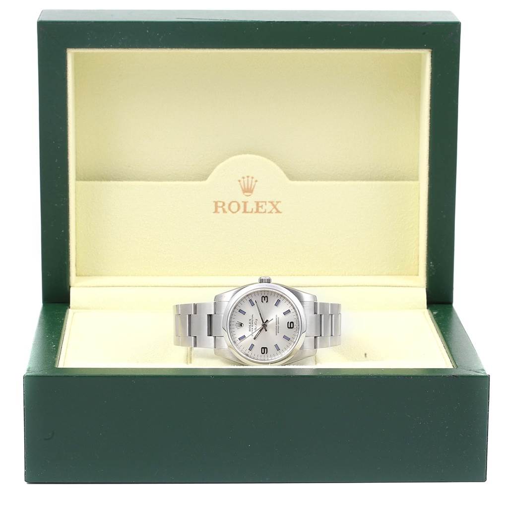 The Rolex Air-King 114200 Men's Stainless Steel Silver Dial 114200 Men's Stainless Steel Silver Dial watch is displayed front-facing in an open green and cream Rolex box.