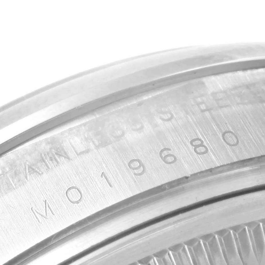 This image shows a close-up of the side and part of the case back of a Rolex Air-King 114200 Men's Stainless Steel Silver Dial 114200 Men's Stainless Steel Silver Dial watch, displaying serial numbers and "STAINLESS STEEL".