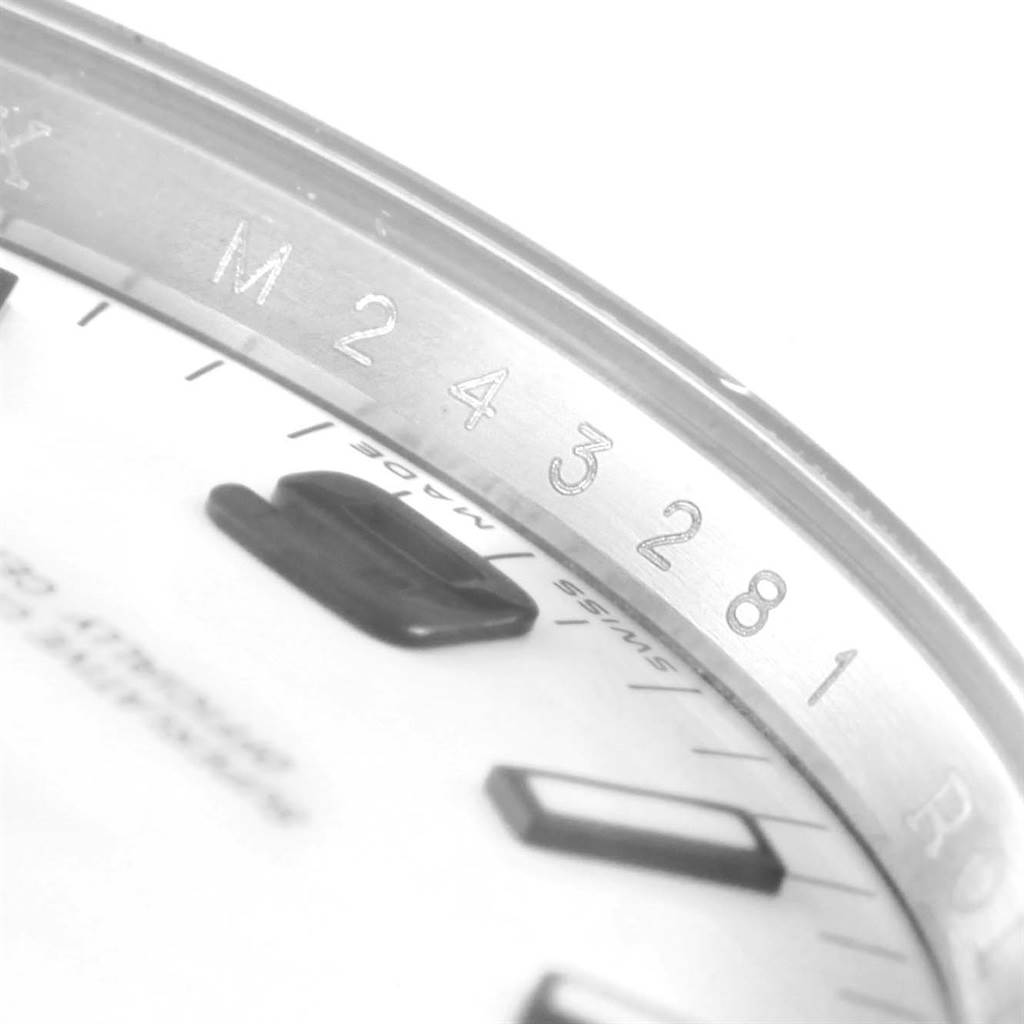 The image shows a close-up angle of the bezel and part of the dial of a Rolex Air-King 114210 Men's Stainless Steel White Dial 114210 Men's Stainless Steel White Dial watch.