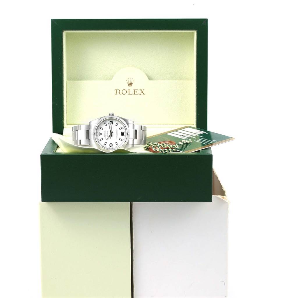 The Rolex Air-King 114210 Men's Stainless Steel White Dial 114210 Men's Stainless Steel White Dial watch is displayed in its open green box along with documentation and tags.
