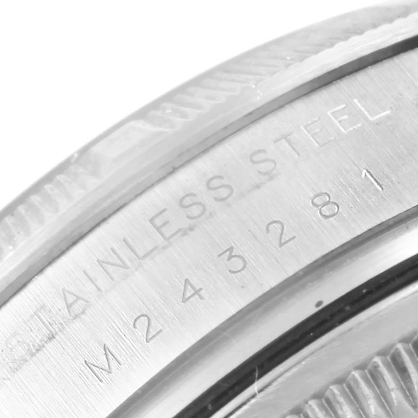 This image shows a close-up of the flange and caseback of a Rolex Air-King 114210 Men's Stainless Steel White Dial 114210 Men's Stainless Steel White Dial watch, with "STAINLESS STEEL" and numbers engraved.