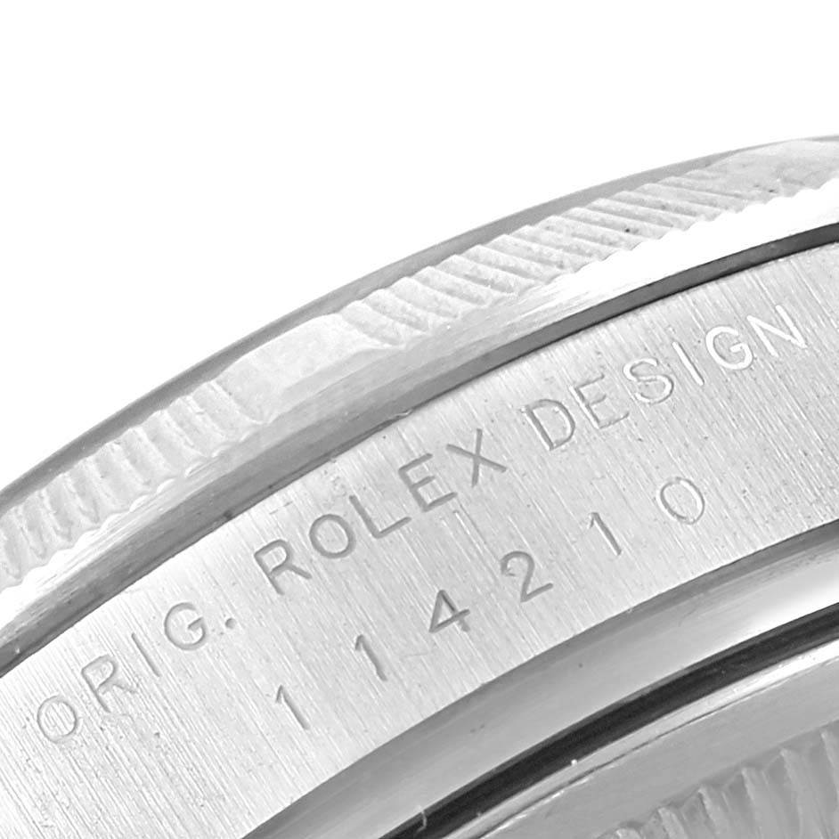 The image shows a close-up of the engraved case back of a Rolex Air-King 114210 Men's Stainless Steel White Dial 114210 Men's Stainless Steel White Dial watch, displaying the model number and "ORIG. ROLEX DESIGN."