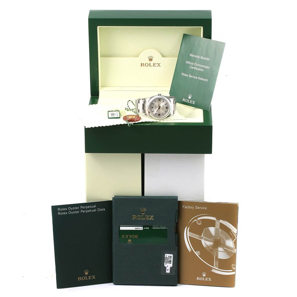 The image shows a Rolex Air-King 114200 Stainless Steel Silver Dial 114200 Stainless Steel Silver Dial watch from the front, with its box, warranty booklet, and factory service booklet.