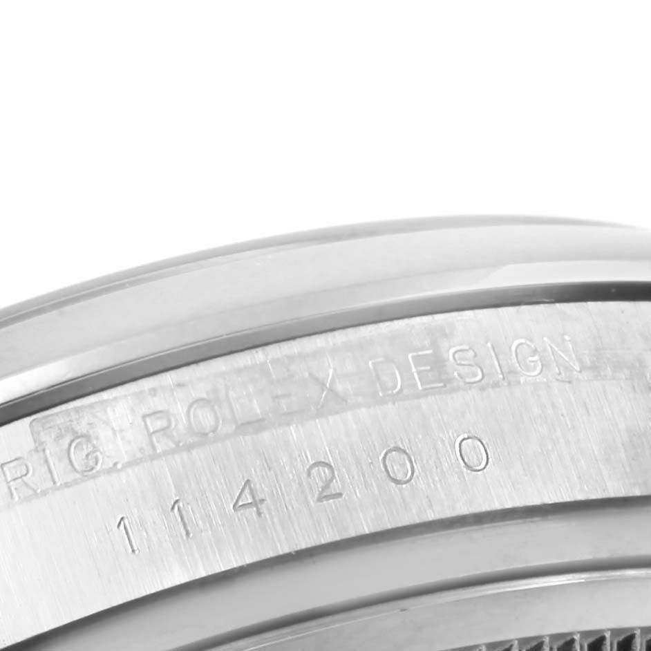 This close-up angle of the Rolex Air-King 114200 Stainless Steel Silver Dial 114200 Stainless Steel Silver Dial watch shows the side of the casing with "ROLEX DESIGN" and the model number 114200 engraved.