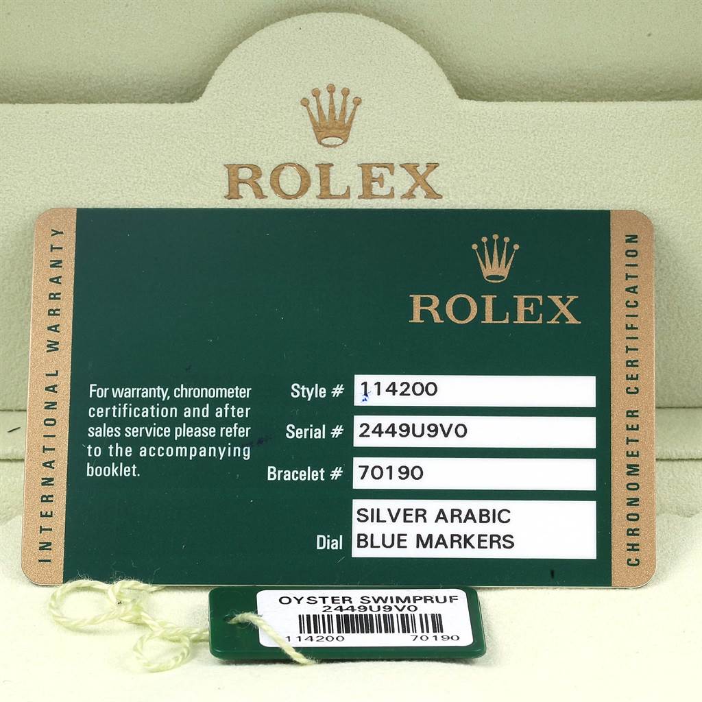 The image shows the warranty card and tags for a Rolex Air-King 114200 Stainless Steel Silver Dial 114200 Stainless Steel Silver Dial model watch.